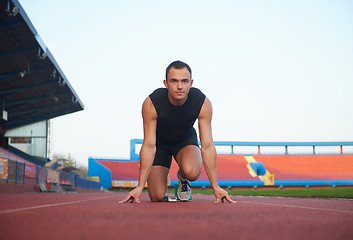 Image showing pixelated design of woman  sprinter leaving starting blocks