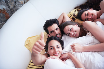 Image showing handsome man in bed with three beautiful woman