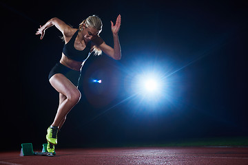 Image showing pixelated design of woman  sprinter leaving starting blocks