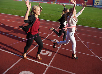 Image showing business people running on racing track