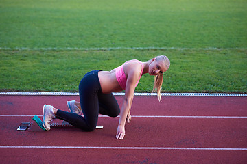 Image showing pixelated design of woman  sprinter leaving starting blocks