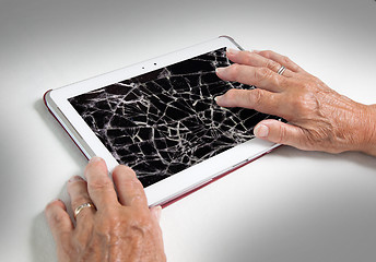 Image showing Senior lady with tablet, cracked screen