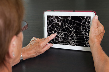 Image showing Senior lady with tablet, cracked screen