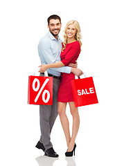 Image showing happy couple with red shopping bags