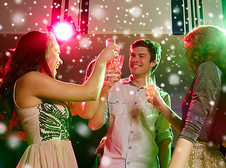 Image showing smiling friends with glasses of champagne in club