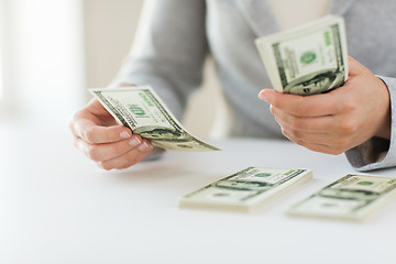 Image showing close up of woman hands counting us dollar money