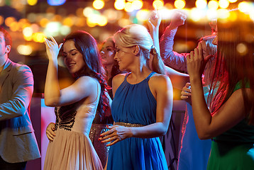 Image showing group of happy friends dancing in night club