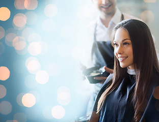 Image showing happy young woman coloring hair at salon