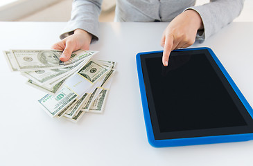 Image showing close up of woman hands with tablet pc and money