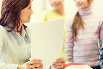 Image showing close up of school kids with teacher in classroom