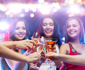 Image showing happy friends clinking glasses at night club