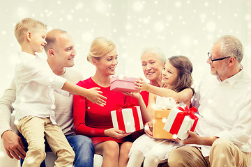 Image showing smiling family with gifts at home