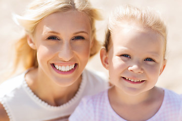 Image showing happy mother and little daughter on summer beach