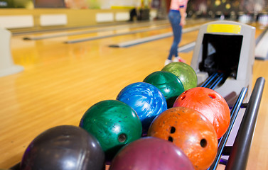 Image showing balls on ball return system in bowling club