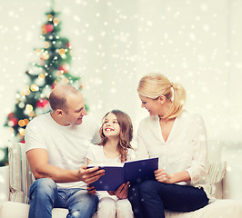 Image showing happy family with book at home