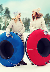 Image showing happy girl friends with snow tubes outdoors