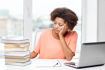 Image showing bored african american woman doing homework home