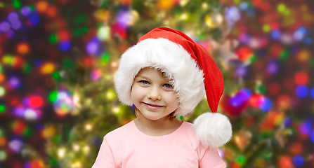 Image showing smiling little girl in santa hat at home