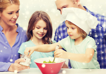 Image showing happy family with two kids making salad at home