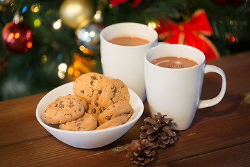 Image showing oat cookies and hot chocolate over christmas tree