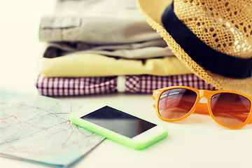 Image showing close up of summer clothes and travel map on table