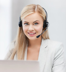 Image showing friendly female helpline operator with laptop