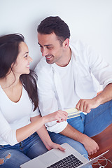 Image showing relaxed young couple working on laptop computer at home