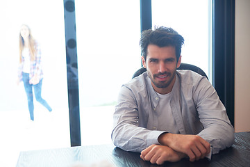 Image showing relaxed young man drink first morning coffee withh rain drops on