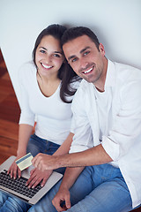 Image showing relaxed young couple working on laptop computer at home