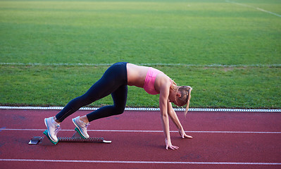 Image showing pixelated design of woman  sprinter leaving starting blocks