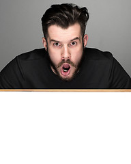 Image showing The surprised man and empty blank over gray background