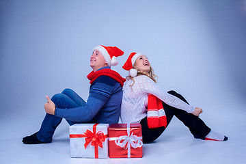 Image showing Lovely christmas couple sitting with presents