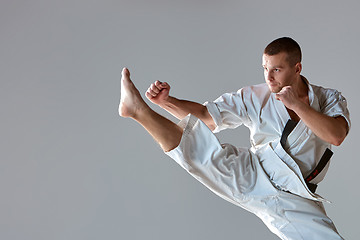 Image showing Man in white kimono training karate