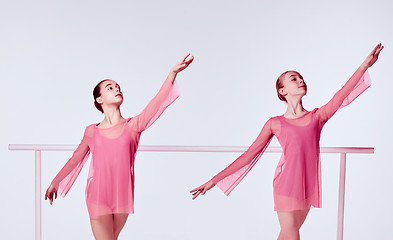Image showing Ballerinas stretching on the bar