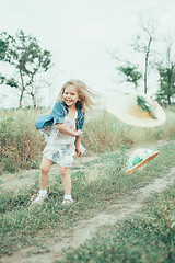 Image showing The young girl on green grass background 