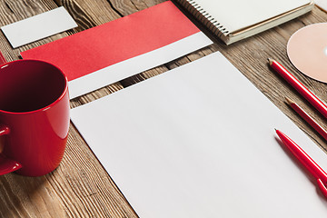 Image showing The mockup on wooden background with red calculator