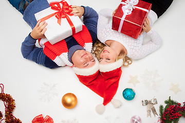Image showing Lovely christmas couple lying with presents