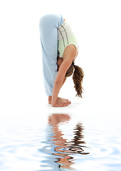 Image showing uttanasana standing forward bend on white sand