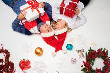 Image showing Lovely christmas couple lying with presents