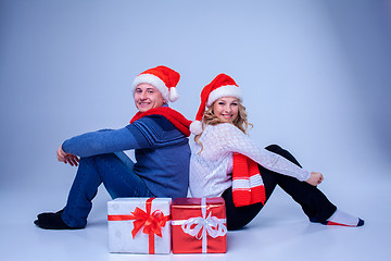 Image showing Lovely christmas couple sitting with presents