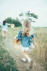 Image showing The young mother and daughter on green grass background 