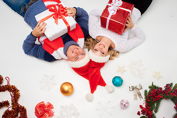 Image showing Lovely christmas couple lying with presents