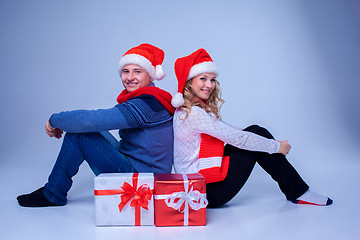 Image showing Lovely christmas couple sitting with presents