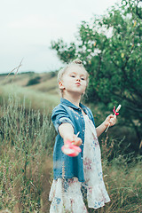 Image showing The young girl on green grass background 