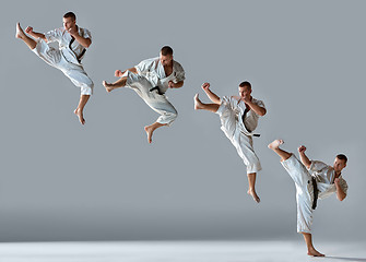 Image showing Man in white kimono training karate