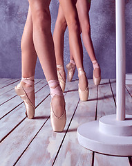Image showing The feet of a young ballerinas in pointe shoes 