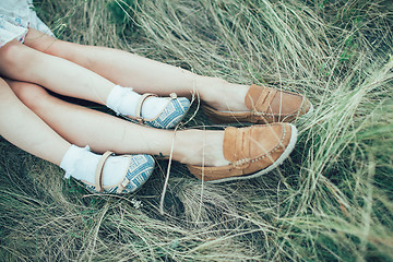 Image showing The young mother and daughter on green grass background 