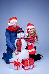 Image showing Lovely christmas couple sitting with presents