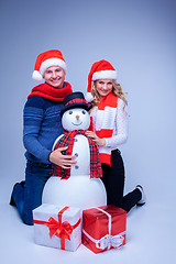 Image showing Lovely christmas couple sitting with presents