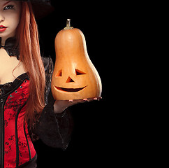 Image showing Girl with Halloween pumpkin on black background